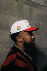 a man wearing a red and white baseball cap